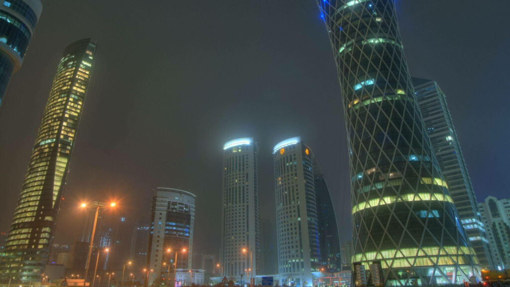 Serene Doha Night View: Misty Skyscrapers & Modern Architecture Wallpaper
