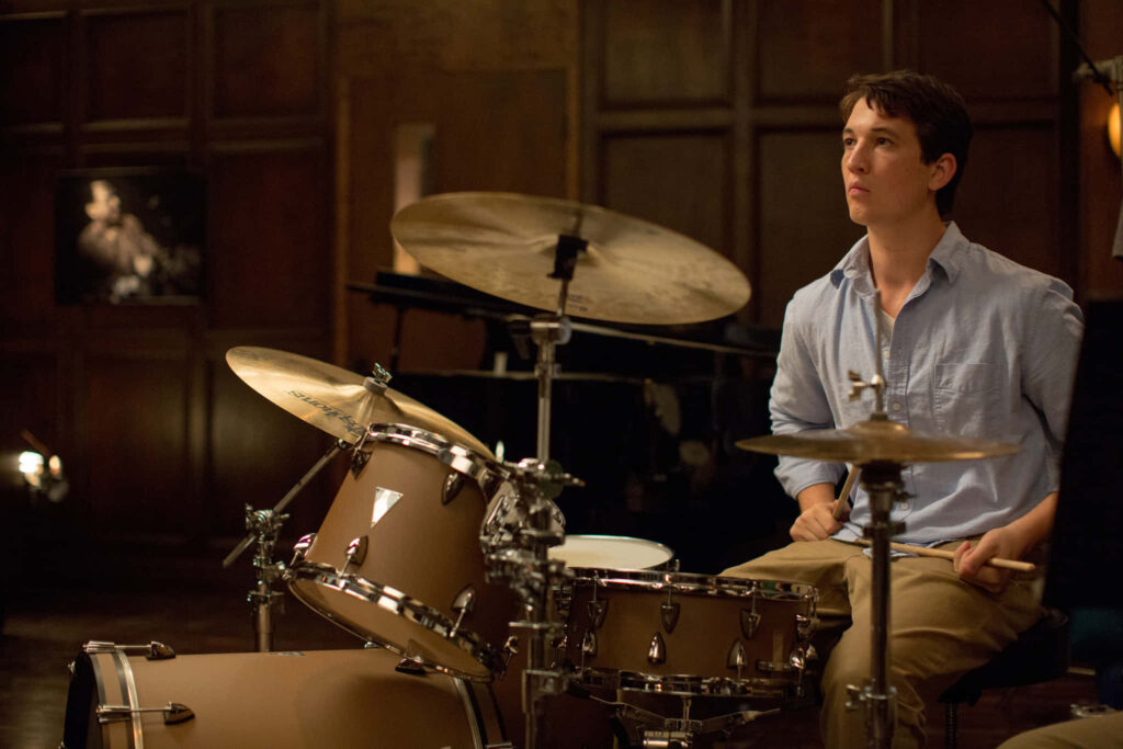 Serene Drummer Contemplation: Dedicated Passion in Dim Studio Wallpaper