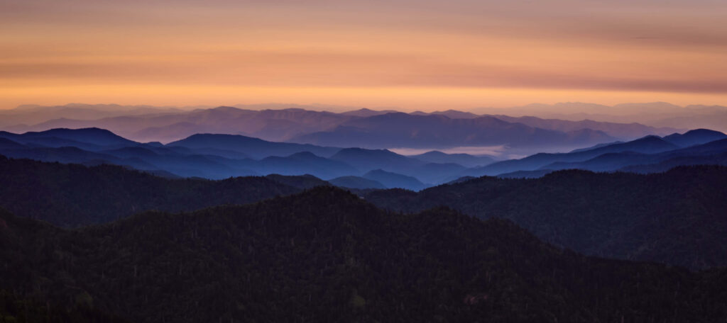 Serene Dual Monitor Wallpaper: Layered Mountain Sunset Background