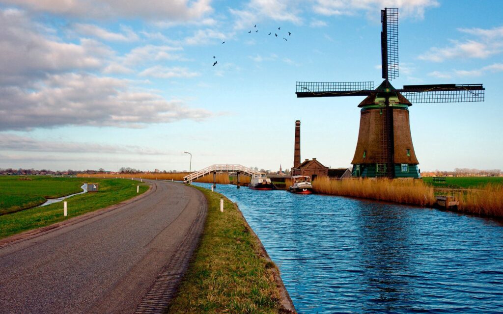 Serene Dutch Landscape Wallpaper with Windmill and River Scene