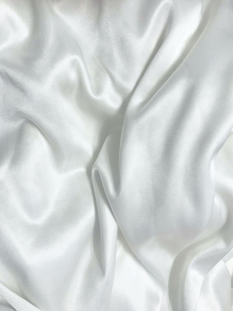 Silken Canvas: Exploring the Beauty of Ivory White Creases in Textured Wallpaper