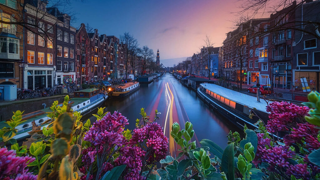 Peaceful Dutch Canal Evening: Serene Wallpaper with Vibrant Flowers