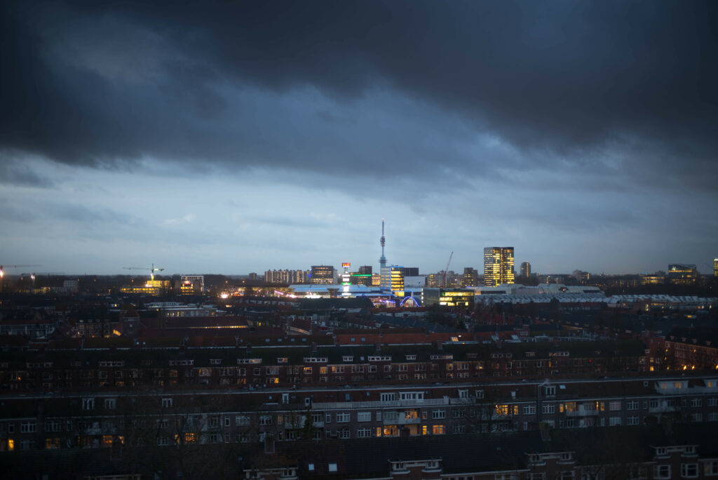 Serene Evening Cityscape Wallpaper: Urban Buildings & Dramatic Sky
