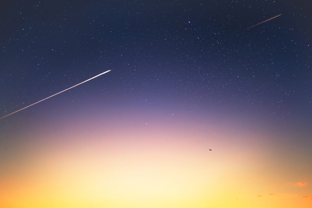 Tranquil Evening Sky Wallpaper with Stars and Meteor Streaks