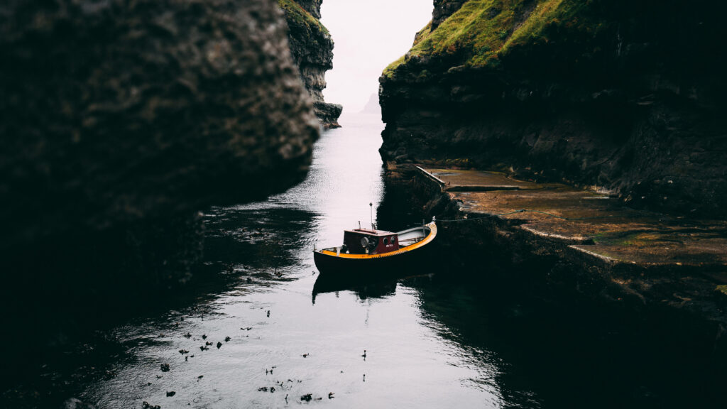 Tranquil Faroe Islands Inlet Wallpaper - Scenic Boat & Cliffs