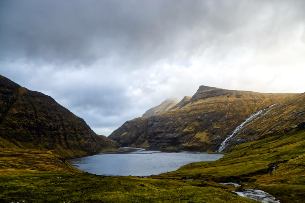 Serene Faroe Islands Wallpaper: Scenic Sea Inlet & Rugged Mountains