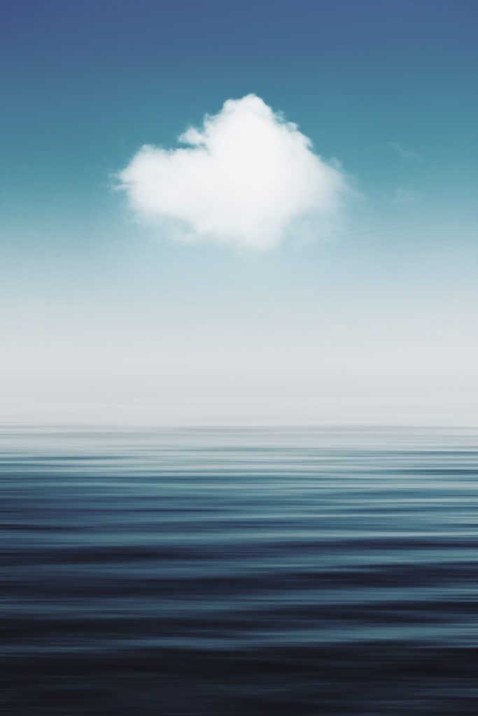 Serene wallpaper with fluffy white cloud over calm reflective water and soft blue gradient sky
