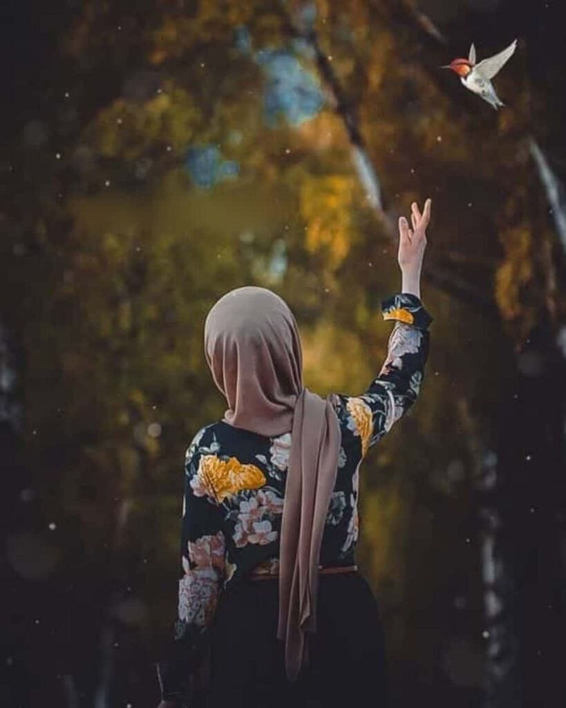 Contemplative Forest Scene: Person Reaching for a Flying Bird Wallpaper