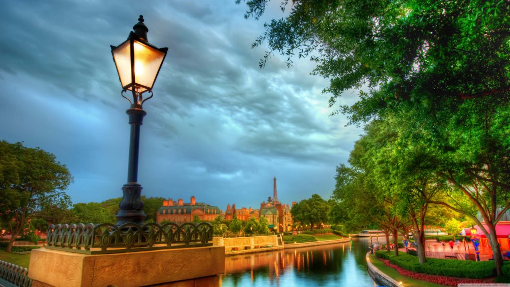 Epcot France Pavilion twilight with glowing lamp Eiffel Tower canal reflection wallpaper background