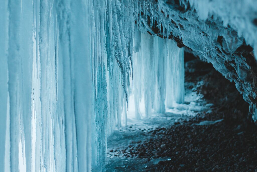 Serene Frozen Cave Wallpaper: Intricate Icicles & Soft Natural Light
