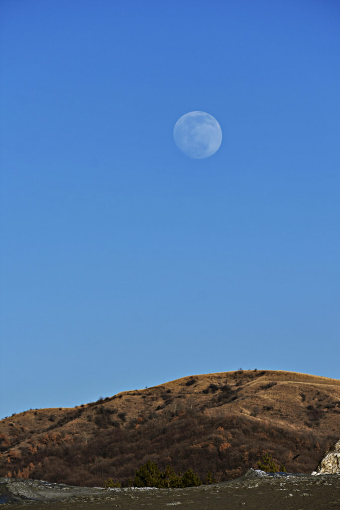 Serene Full Moon Wallpaper: Blue Sky & Scenic Hilly Landscape