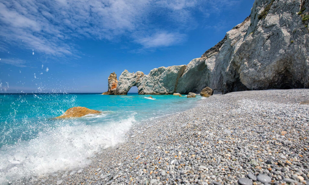 Tranquil Greek Beach Wallpaper: Azure Waters & Pebbled Shore