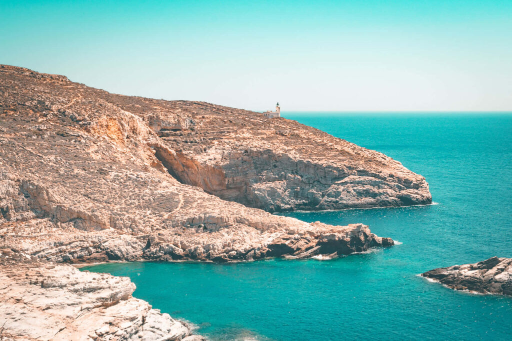 Serene Greek Beach Wallpaper: Turquoise Waters & Rugged Cliffs
