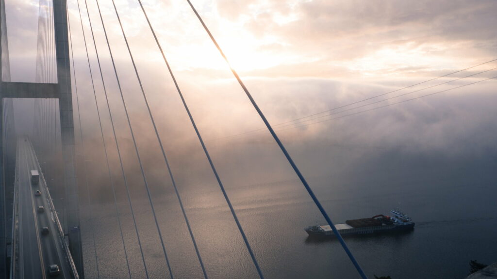 Tranquil HD Wallpaper: Bridge Over Calm Waters with Ethereal Clouds