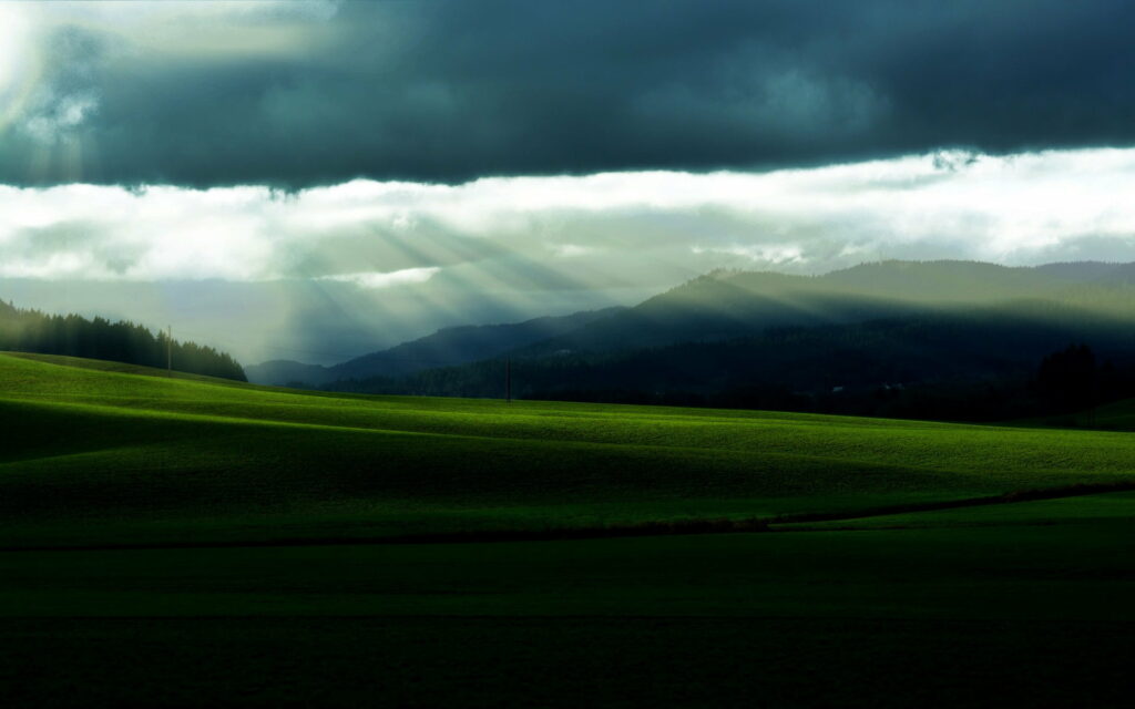 Serene Green Hills HD Wallpaper with Dramatic Sun Rays