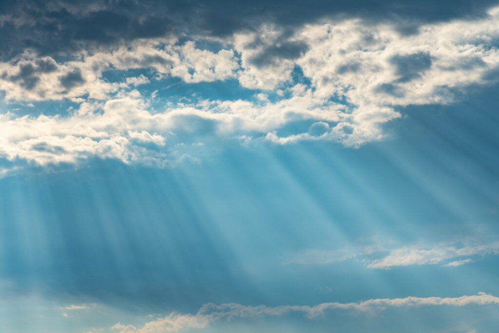 Serene HD Sky Wallpaper: Sunlight Through Ethereal Clouds Background
