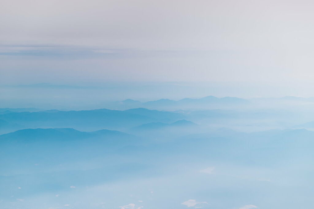 Serene Mountain Background with Wispy Clouds - HD Wallpaper