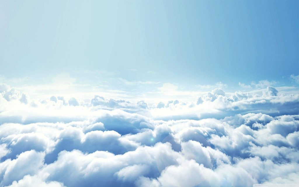 Aerial view of soft white clouds illuminated by bright ethereal sunlight peaceful sky wallpaper