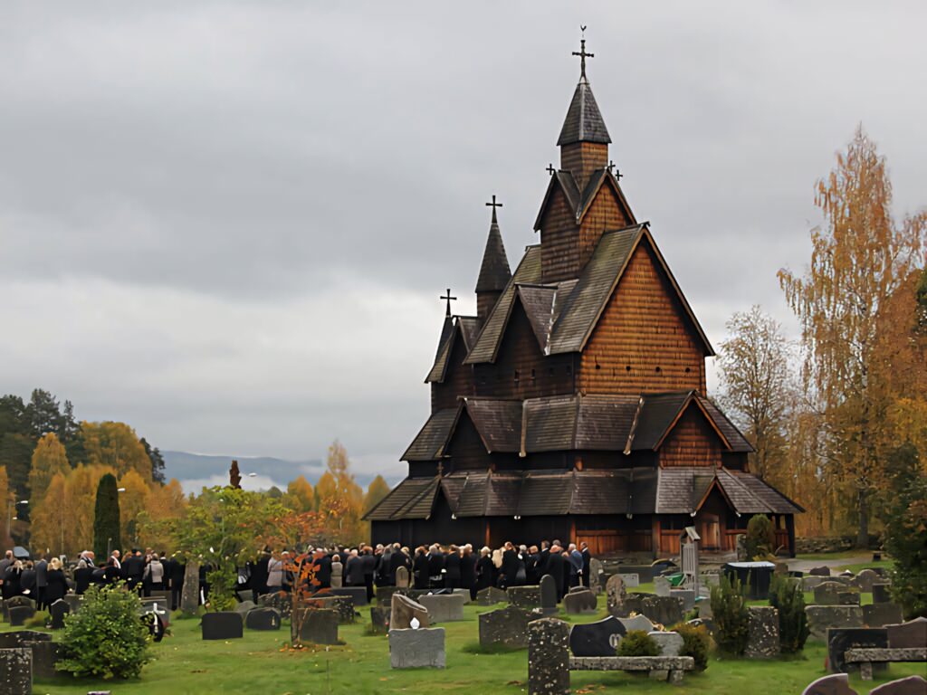 Autumn Serenity: Heddal Stave Church Wallpaper with Vibrant Trees
