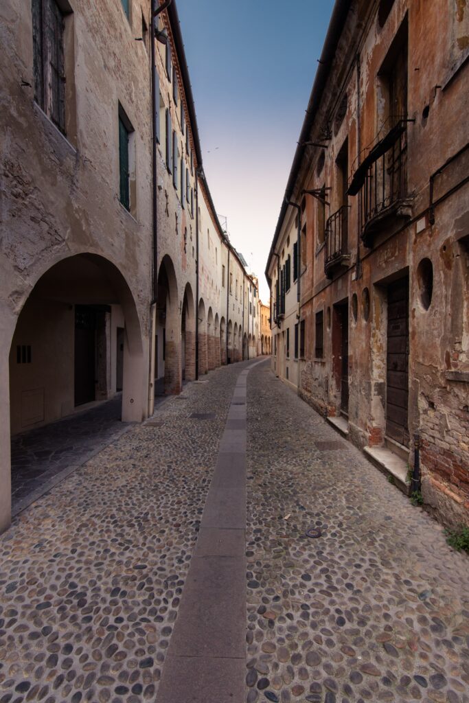 Serene Historic City Wallpaper: Rustic Buildings & Cobblestone Charm