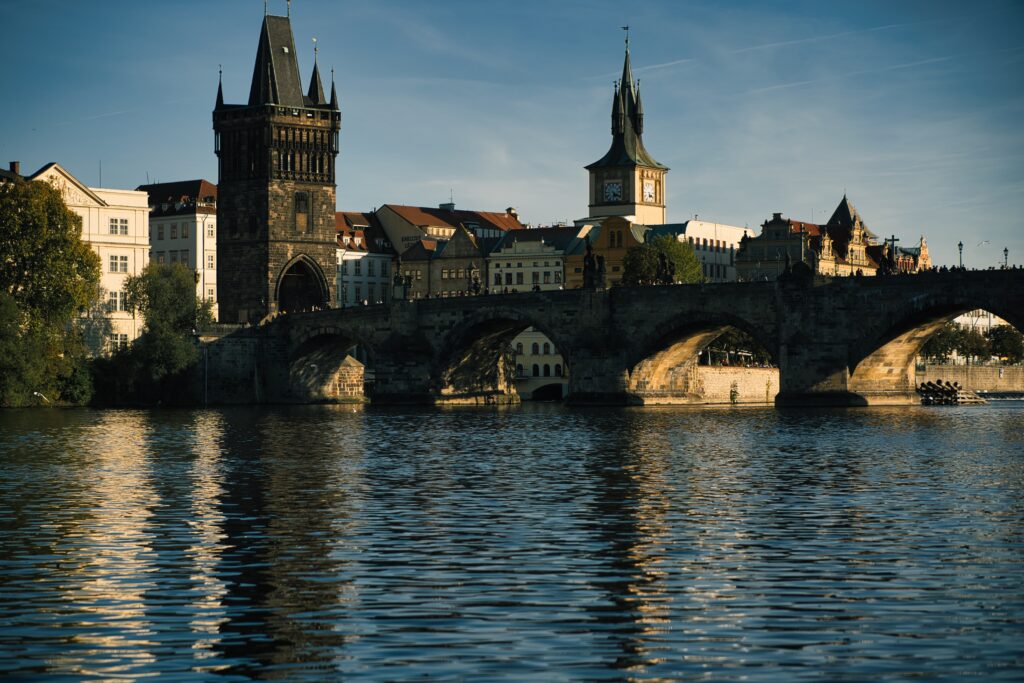 Serene Historic Cityscape Wallpaper: Stone Bridge & Tower View