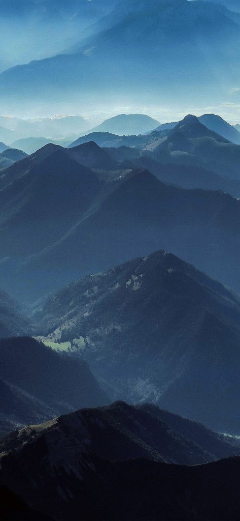 Layered blue mountain ranges fading into a hazy horizon iPhone wallpaper background nature view