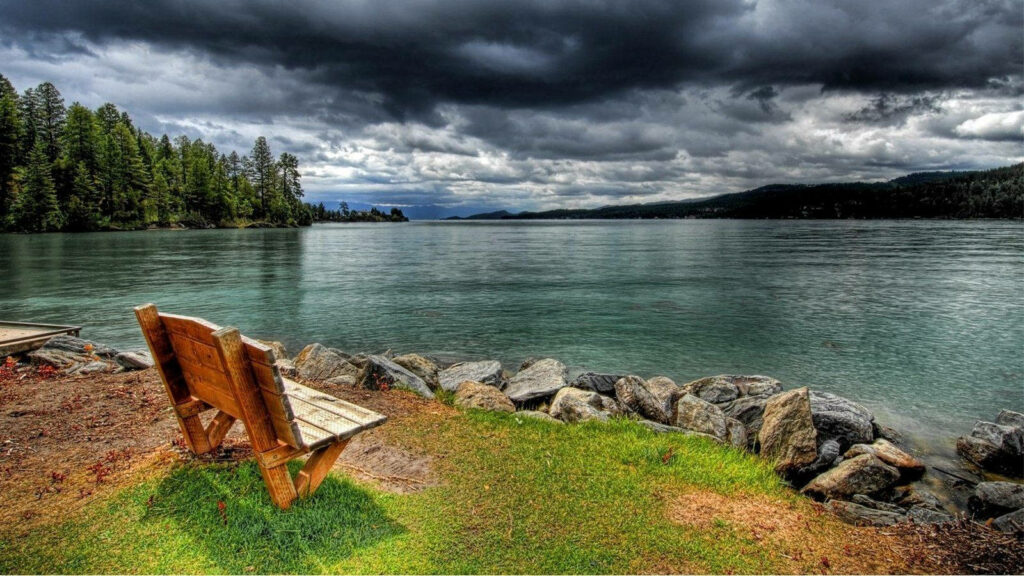 Serene Lakeside Wallpaper: Rustic Bench & Tranquil Water Reflections