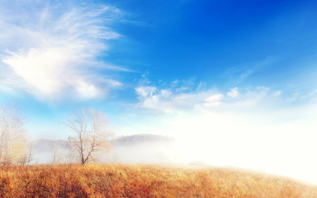 Serene HD Landscape Wallpaper: Blue Sky Meets Foggy Horizon