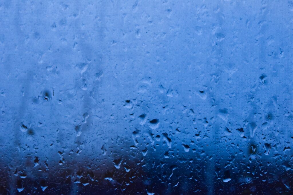 Tranquil Macro Rain Droplets on Glass - Blue Toned Wallpaper