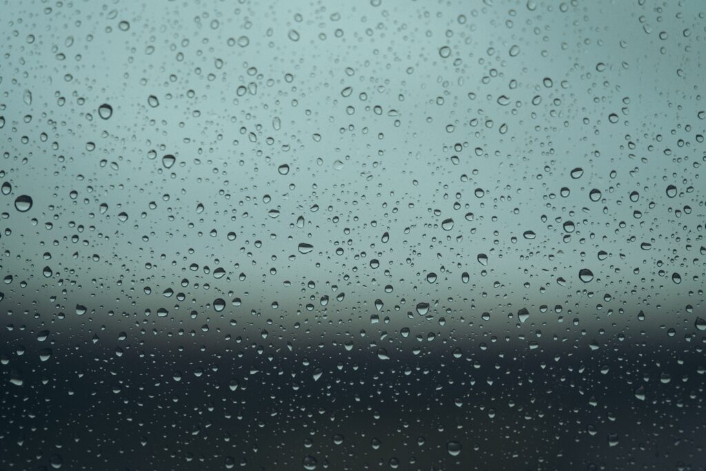 Serene Macro Water Drops on Glass: Detailed Wallpaper Background