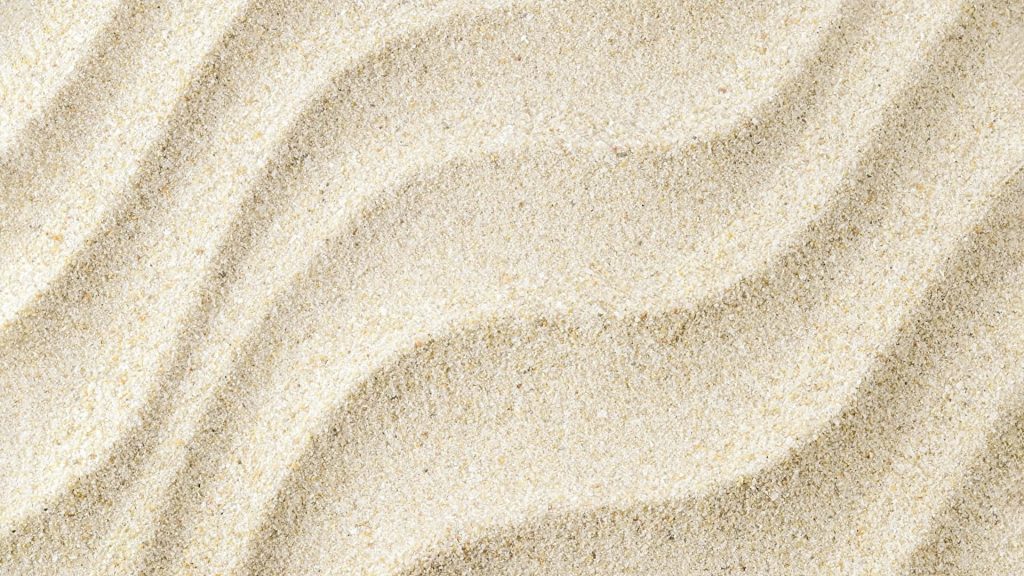 Macro photo of natural marine sand with rippled texture warm beige calming desktop wallpaper