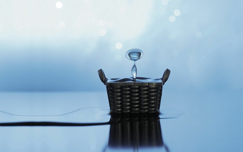 Serene Metallic Basket on Reflective Surface - Minimalist Wallpaper