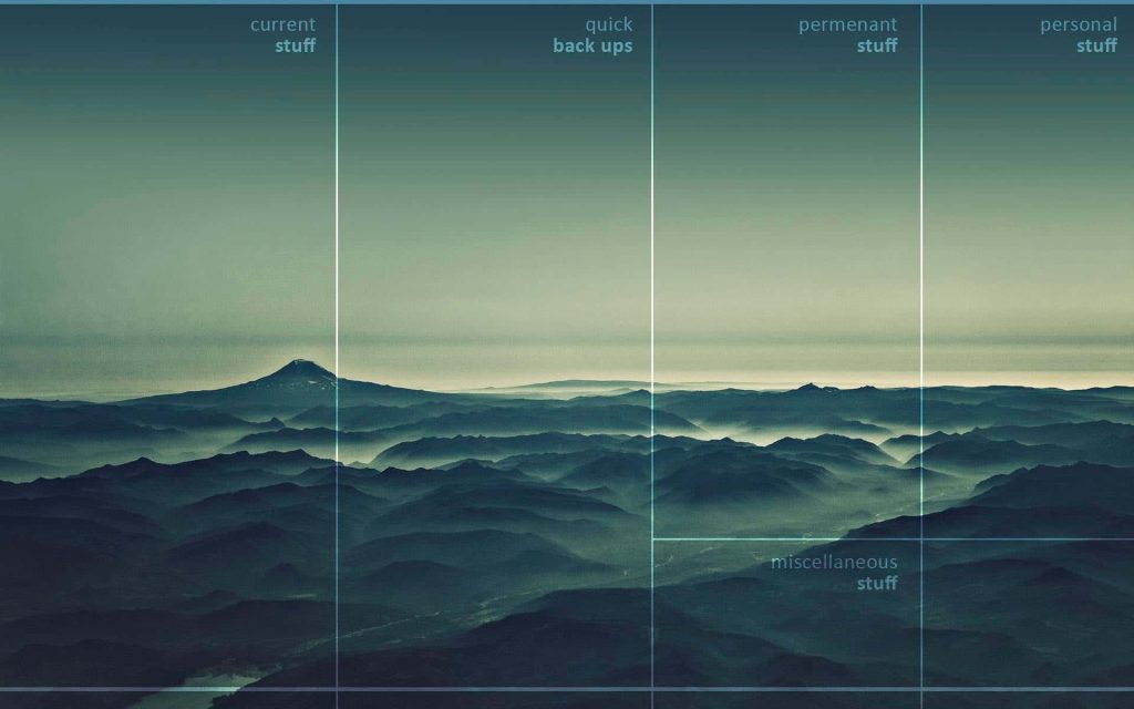 Serene desktop organizer wallpaper with misty mountain landscape and clean grid layout for files