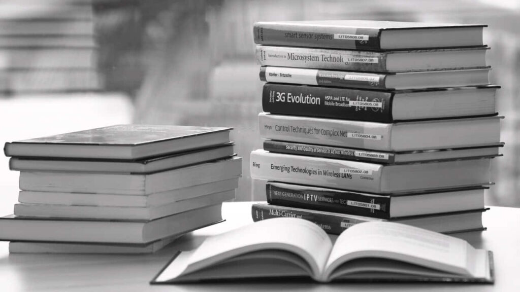 Tranquil Monochrome Wallpaper: Open Book Among Nature & Stacks