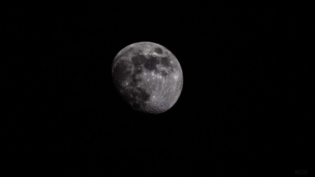 Serene Moon Wallpaper: Striking Lunar Image on Black Background