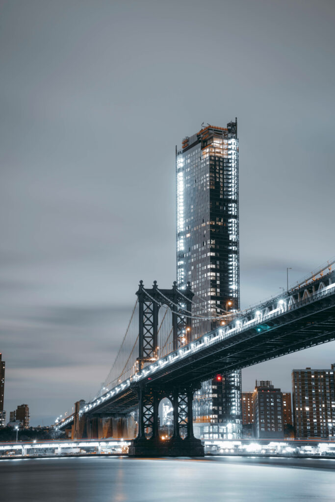 Serene Cityscape Wallpaper: Illuminated Bridge & Skyscraper at Dawn