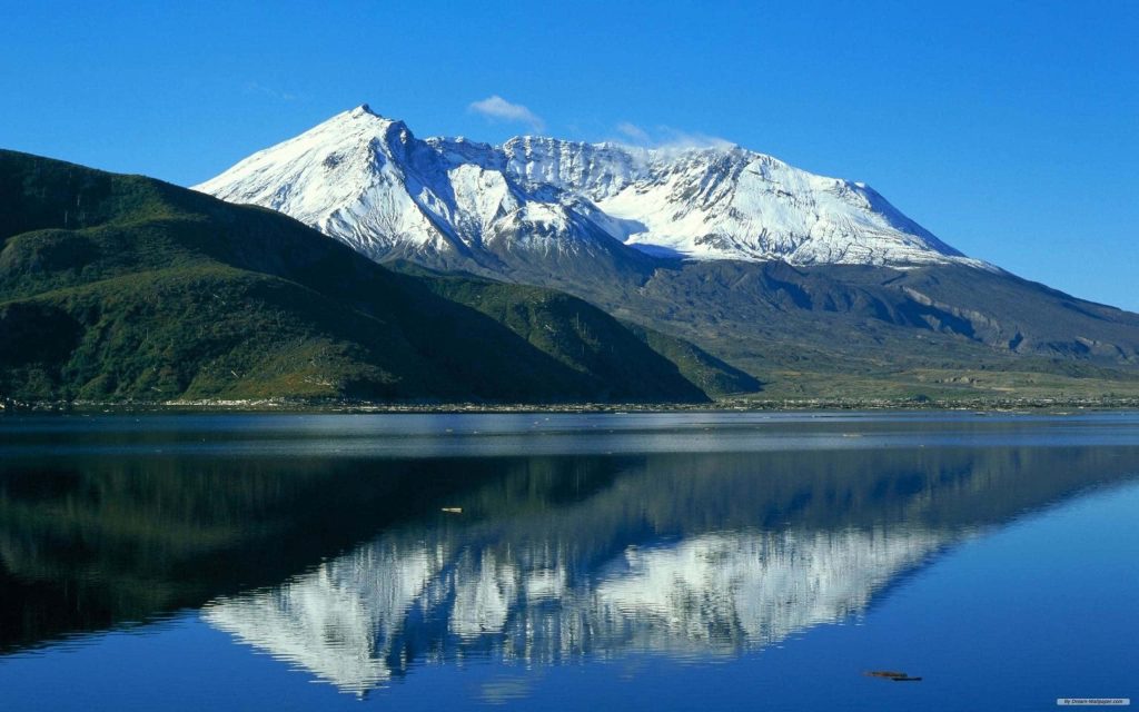 Snow-capped Mount St Helens reflected in calm water under clear blue sky scenic nature wallpaper