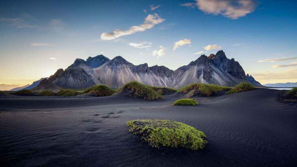Majestic Mountains Behind Black Sand Dunes: Nature's Serene Beauty Wallpaper