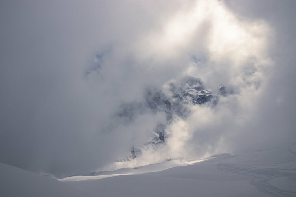 Serene Mountain Landscape Wallpaper: Snowy Peaks & Misty Clouds