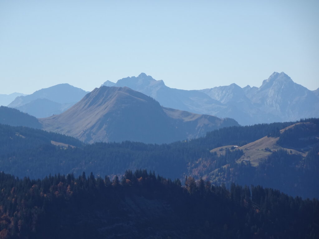 Serene mountain landscape wallpaper with layered ridges dark forests and soft blue tones