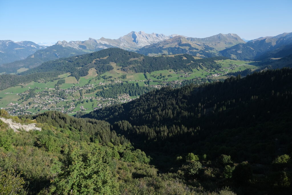 Panoramic wallpaper of rolling mountains lush forests and green valley with scattered villages