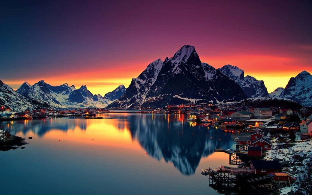 Serene Mountain Sunset Wallpaper: Calm Waters & Peaceful Village