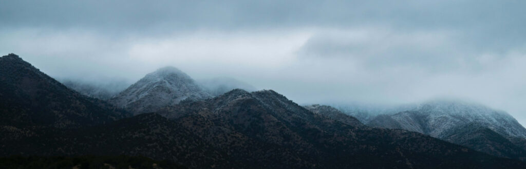 Serene Mountain Mist Wallpaper for a Modern Workspace Background