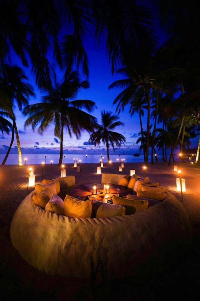 Serene Night Beach Wallpaper with Silhouetted Palms & Candlelight
