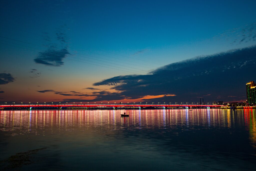Serene Night Cityscape Wallpaper: Bridge Reflection & Twilight Sky