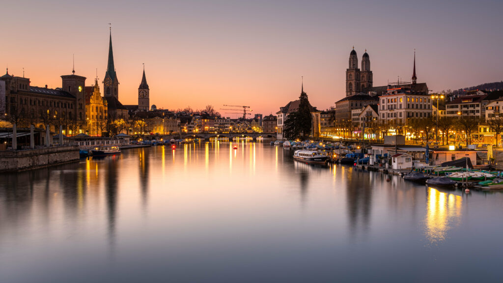 Serene Night Cityscape Wallpaper: River, Historic Towers & Twilit Sky