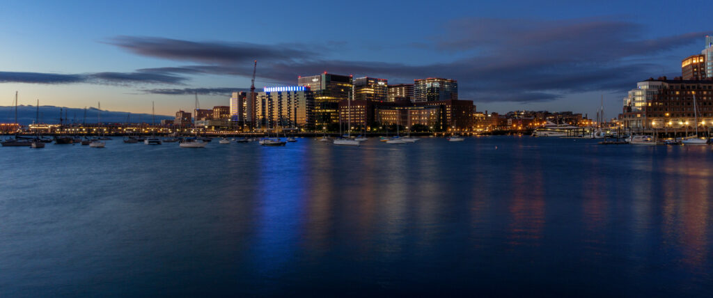 Serene Night Cityscape Wallpaper: Urban Lights & Calm Sea Beauty