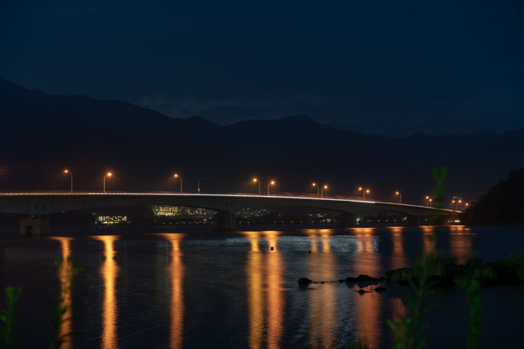 Serene Night Scene Wallpaper: Vibrant Bridge & Water Reflections