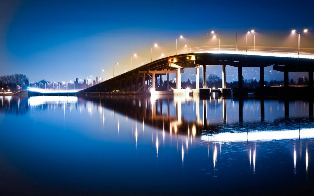 Tranquil Bridge Reflection: Serene Night Scene Wallpaper Background