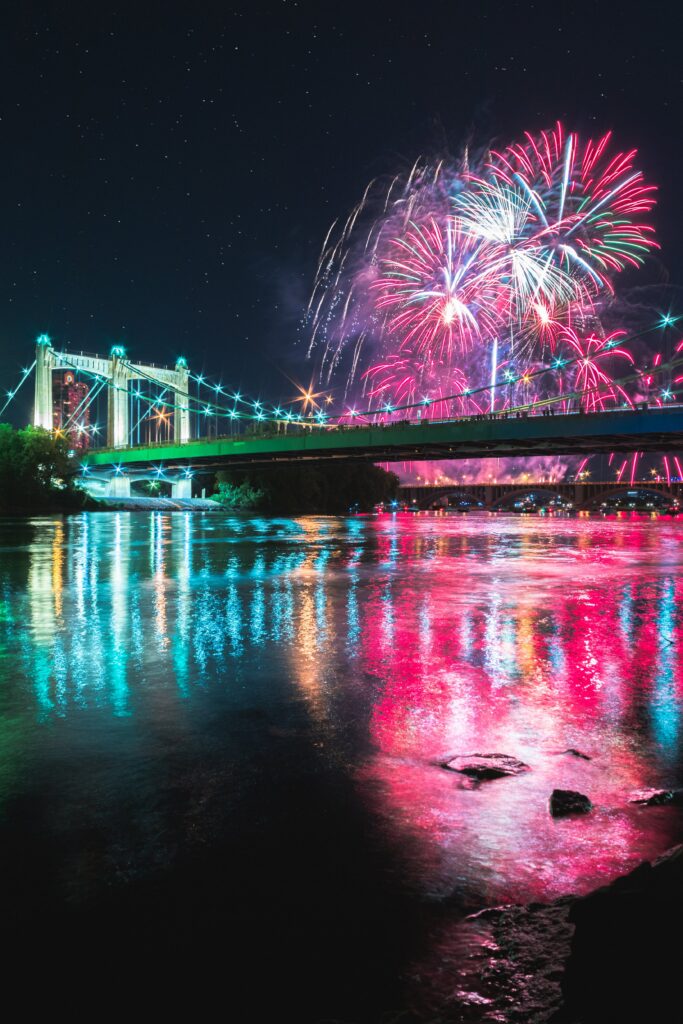 Serene Night Wallpaper: Bridge, Fireworks & Starry Reflections